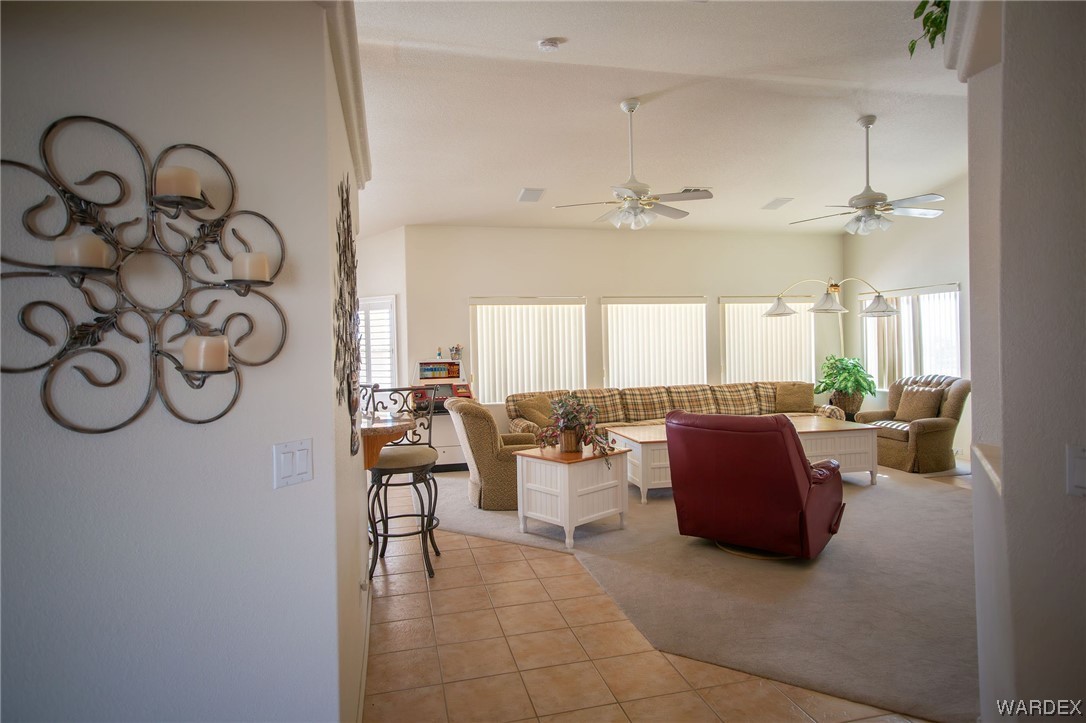 2660 Pegasus Ranch Road Bullhead City, AZ 86429 - Photo 9 of 57 a living room with furniture a large window and a chandelier