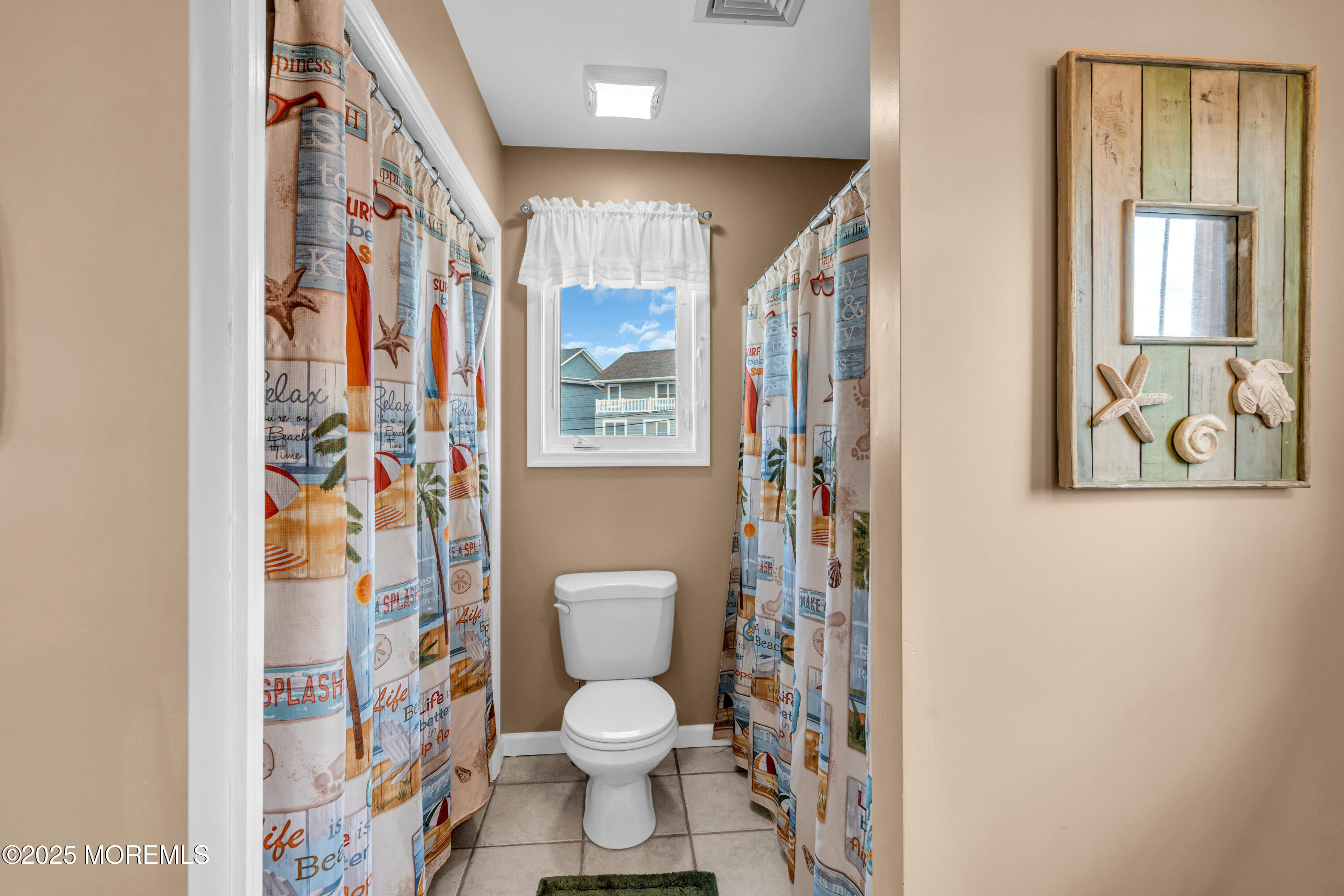 316 Ormond Drive Lavallette, NJ 08735 - Photo 13 of 29 a white toilet sitting next to a shower curtain