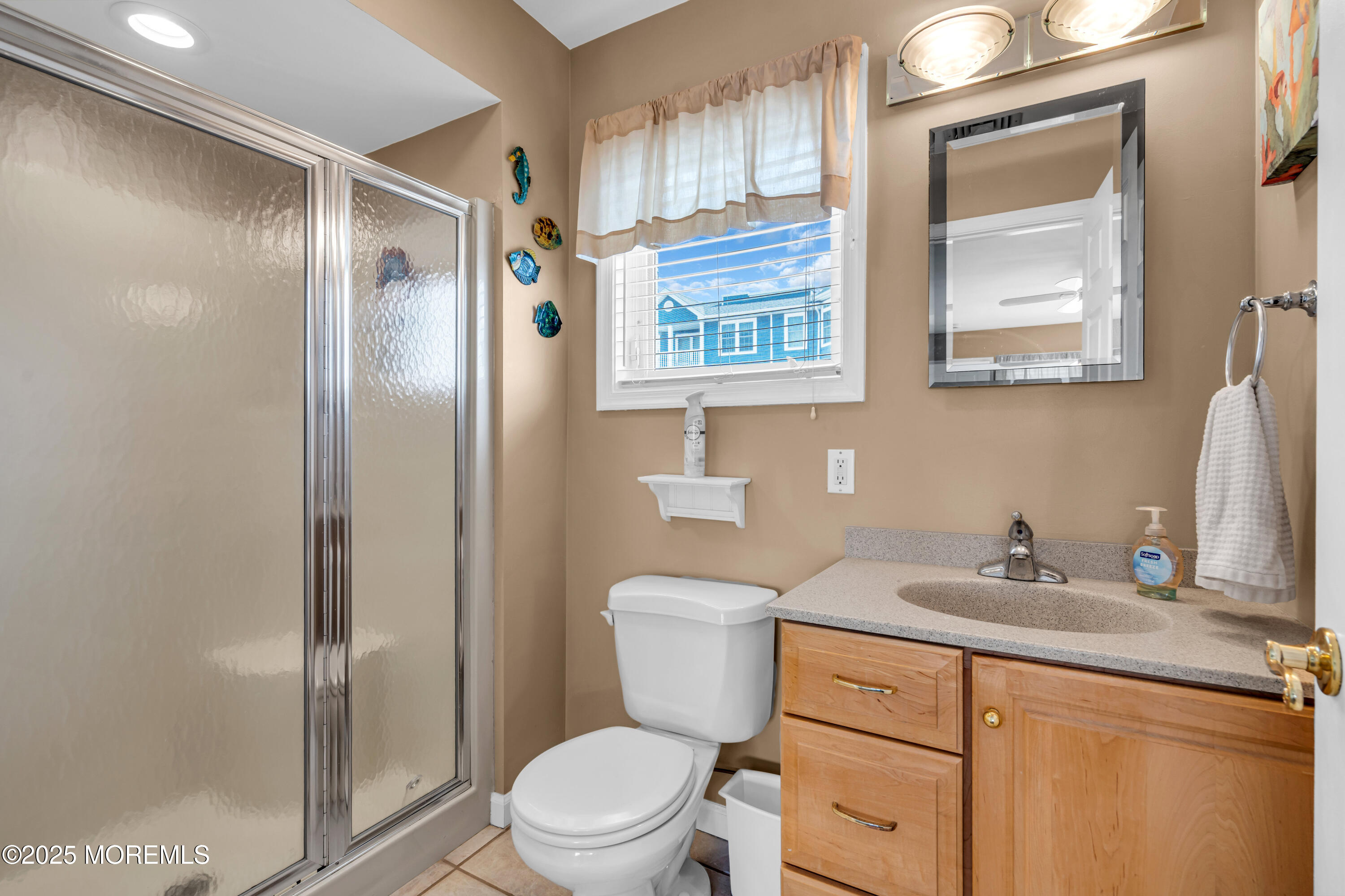 316 Ormond Drive Lavallette, NJ 08735 - Photo 14 of 29 a bathroom with a toilet sink vanity and mirror
