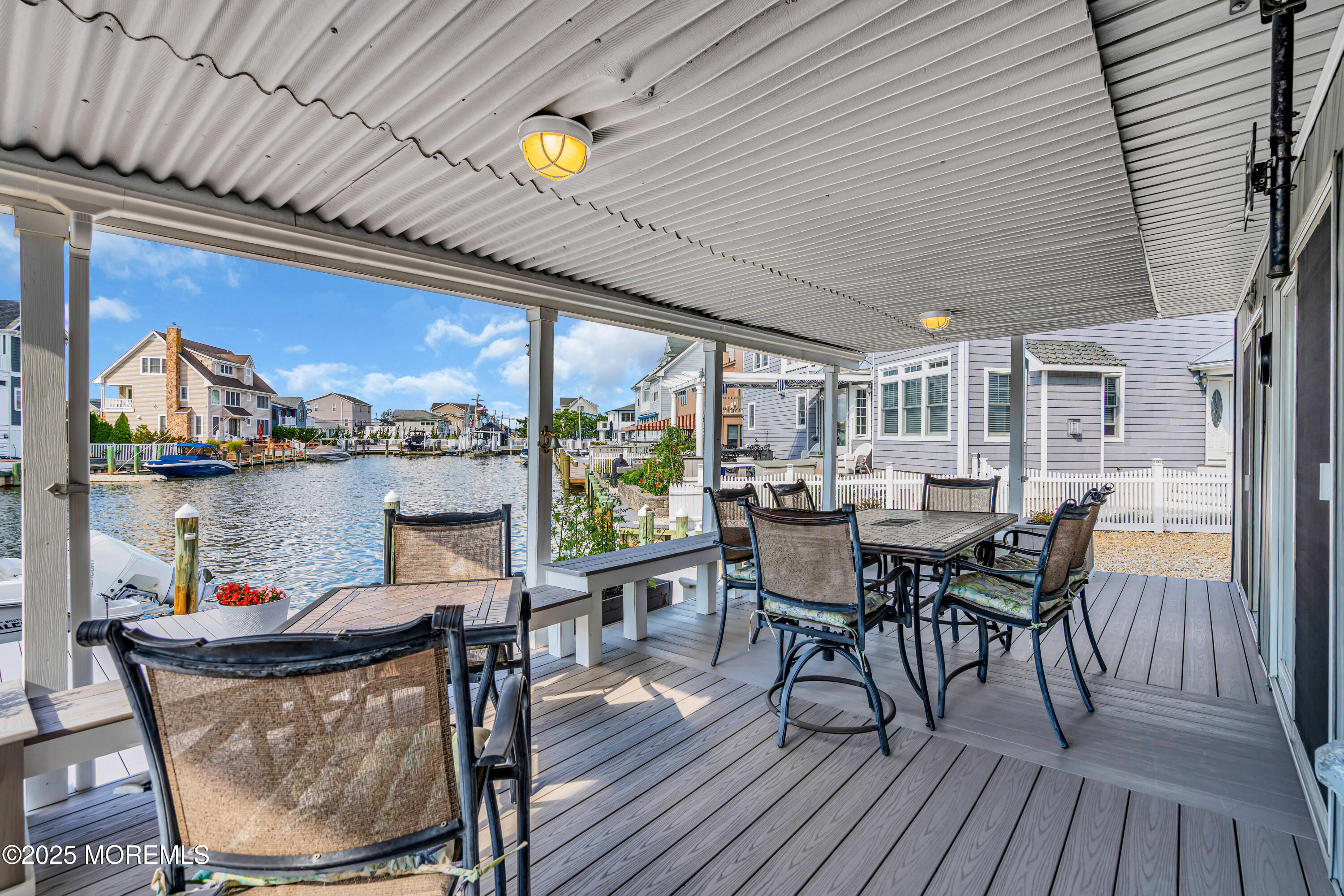 316 Ormond Drive Lavallette, NJ 08735 - Photo 25 of 29 a view of a dining table and chairs in the balcony