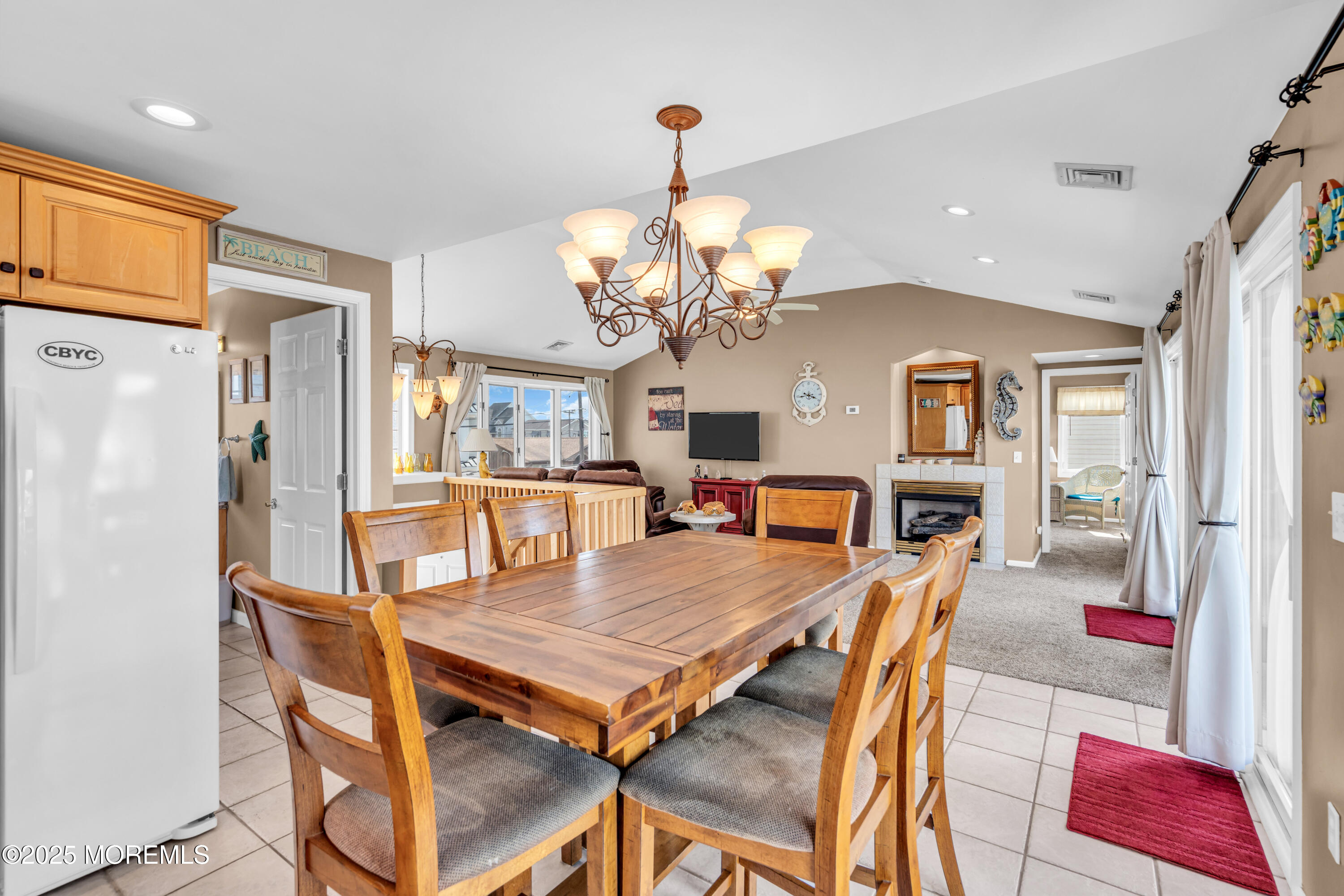 316 Ormond Drive Lavallette, NJ 08735 - Photo 6 of 29 a dining room with wooden floor a chandelier a wooden table and chairs
