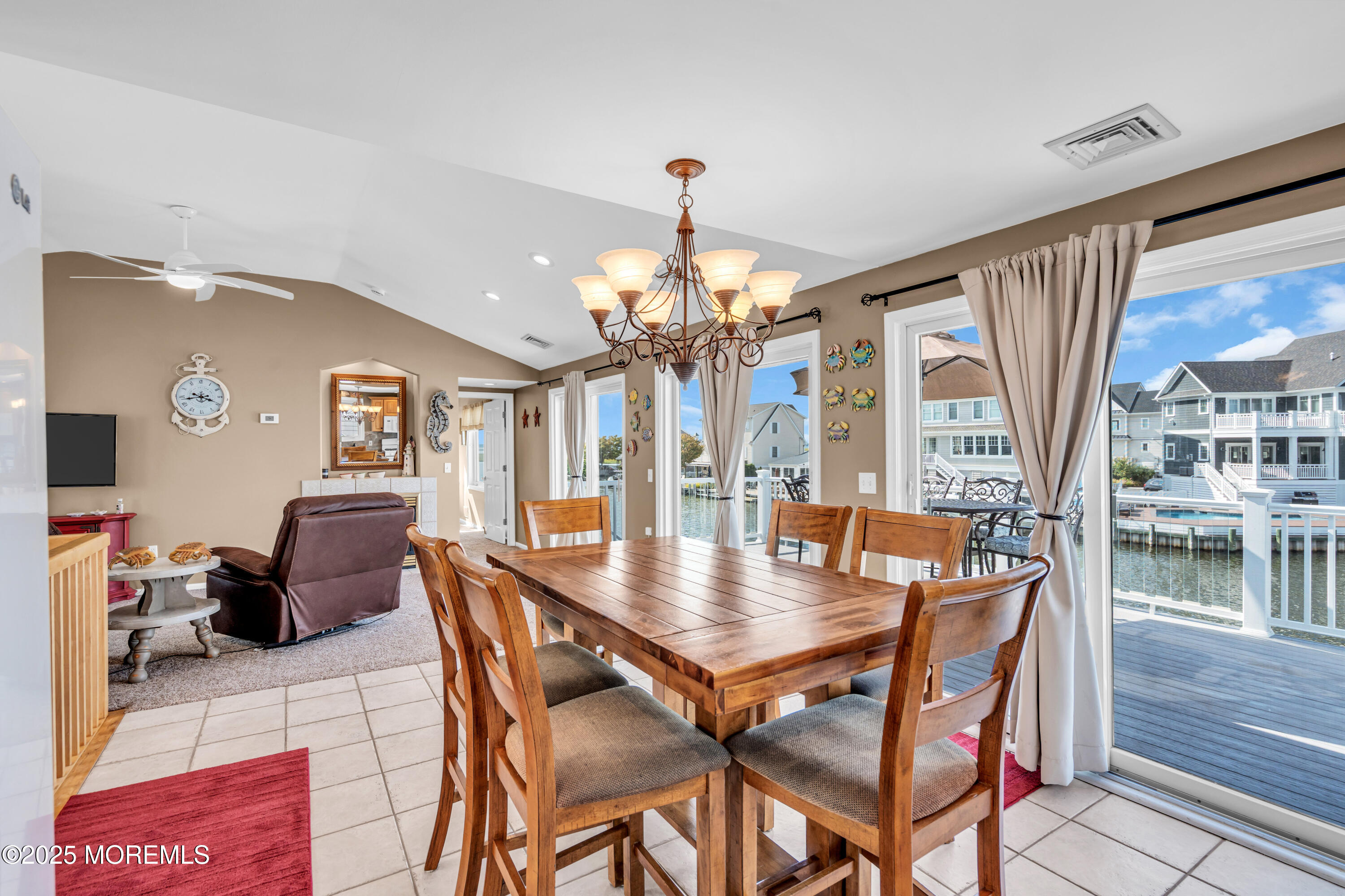 316 Ormond Drive Lavallette, NJ 08735 - Photo 7 of 29 a dining room with furniture a chandelier and wooden floor