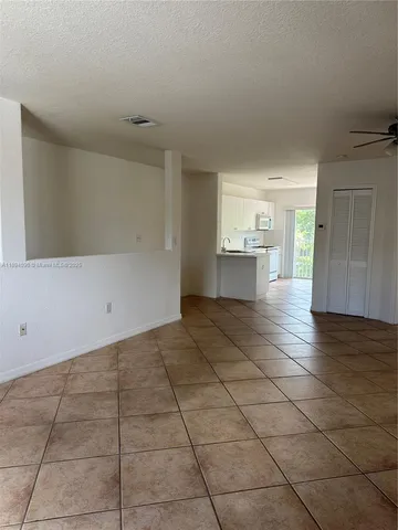 a view of a kitchen with a sink and cabinets
