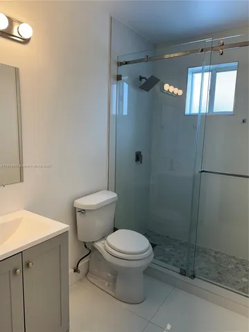 a white toilet sitting next to a bathroom sink