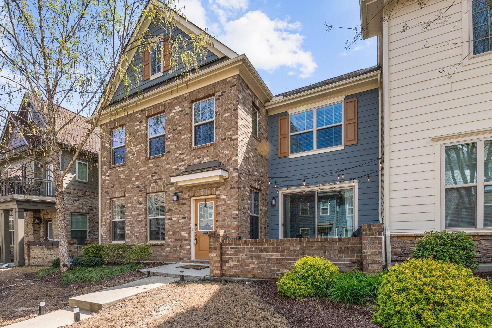 9304 Sevillanos Walk Raleigh, NC 27617 - Photo 1 of 41 front view of a brick house with a yard
