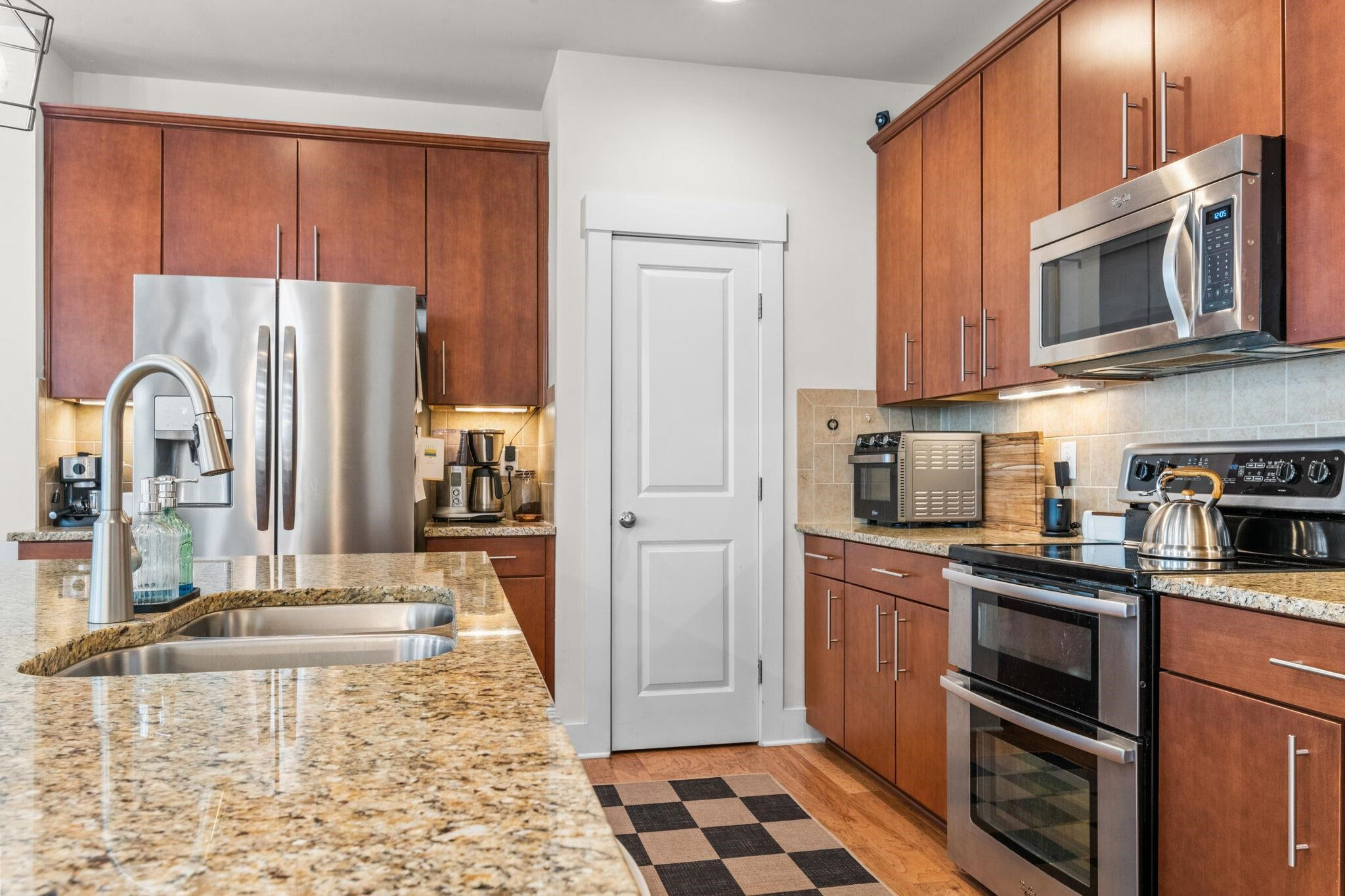 9304 Sevillanos Walk Raleigh, NC 27617 - Photo 15 of 41 a kitchen with stainless steel appliances granite countertop a refrigerator stove and sink
