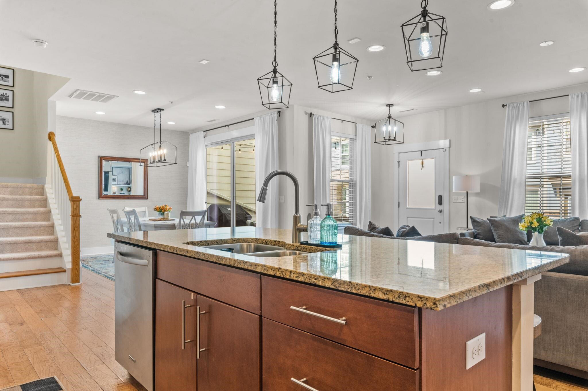 9304 Sevillanos Walk Raleigh, NC 27617 - Photo 16 of 41 a kitchen with stainless steel appliances granite countertop a sink a stove and a wooden cabinets