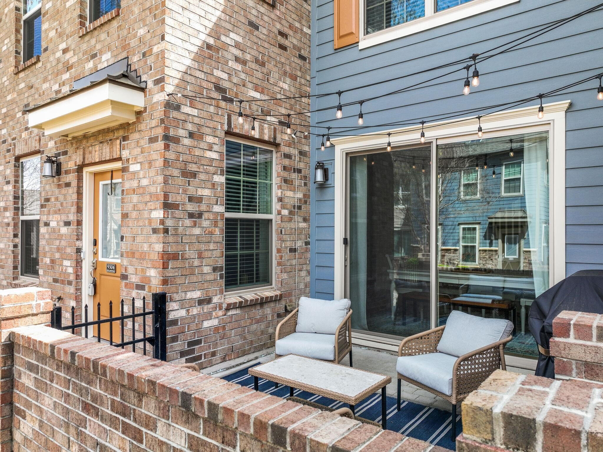 9304 Sevillanos Walk Raleigh, NC 27617 - Photo 3 of 41 a view of a patio with couches table and chairs and potted plants