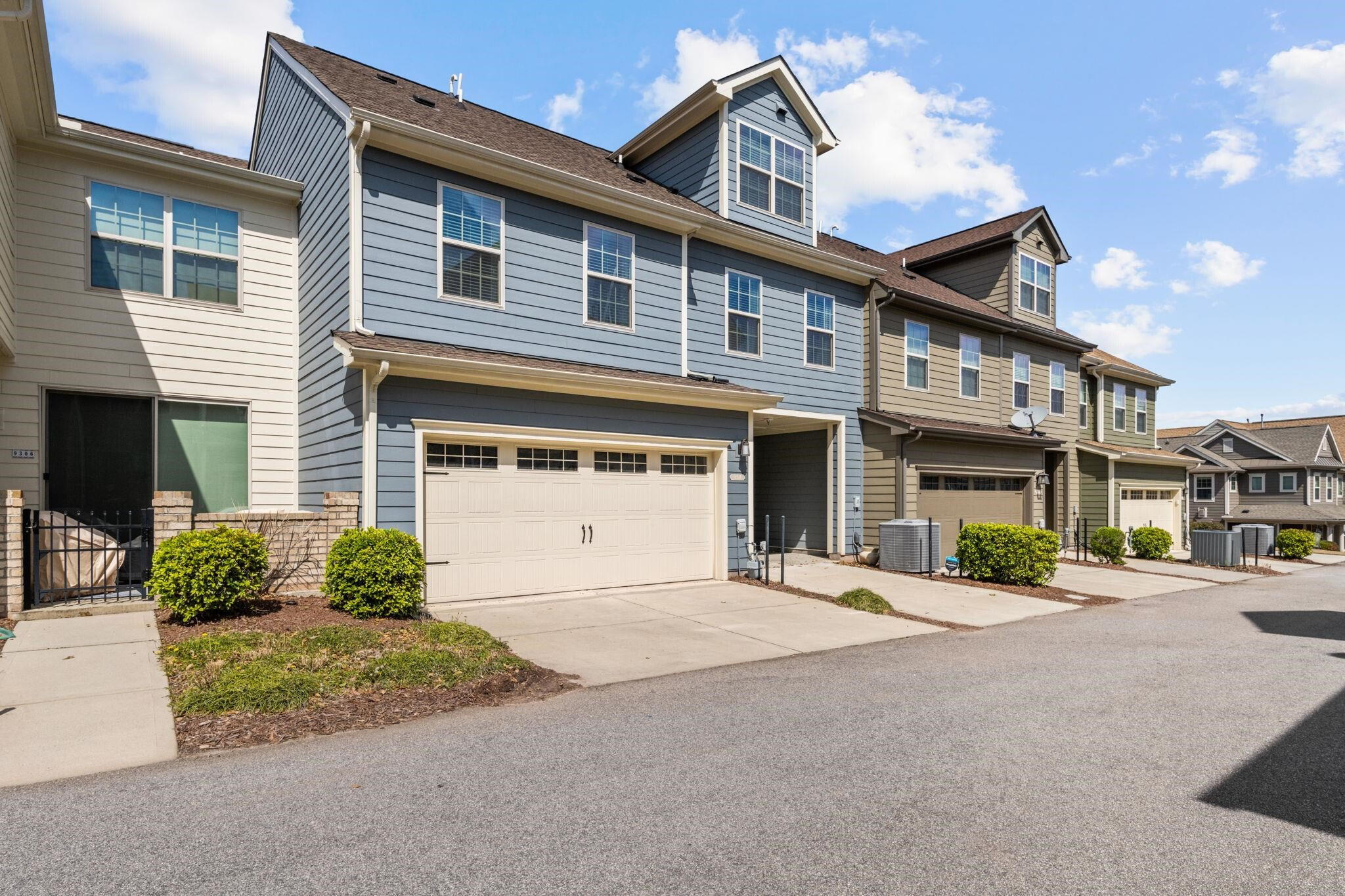 9304 Sevillanos Walk Raleigh, NC 27617 - Photo 38 of 41 a front view of a house with a yard and garage