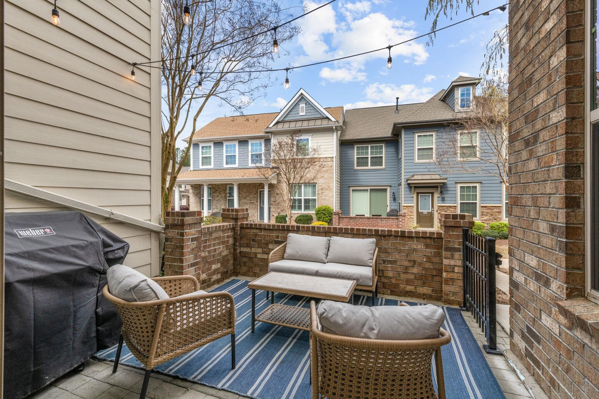 9304 Sevillanos Walk Raleigh, NC 27617 - Photo 4 of 41 a view of house with a chairs and table in a patio