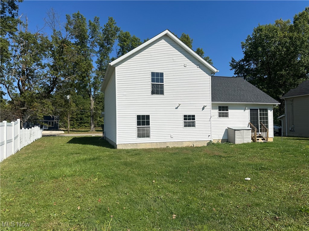 9137 Maple Grove Road Windham, OH 44288 - Photo 5 of 17 Back of house featuring roof with shingles