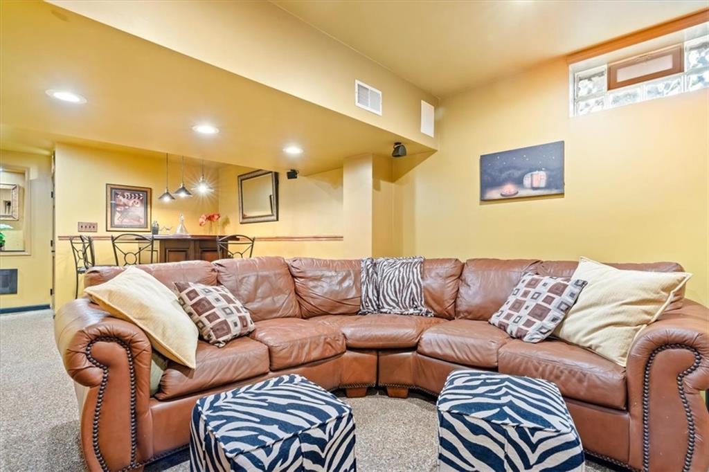 216 Lori Road Gibsonia, PA 15044 - Photo 43 of 50 Bar area. Surround sound. This isn’t a forgotten basement. It’s a finished extension of the lifestyle — game nights, movie marathons, gatherings that extend beyond the main floor.