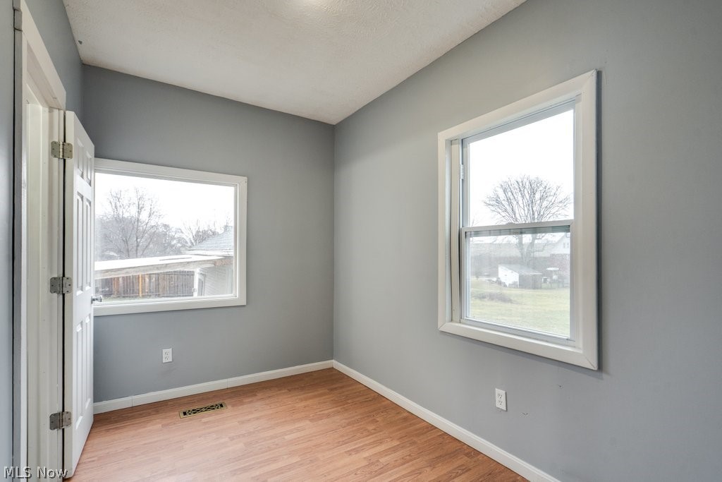 1607 9th Street Southwest Canton, OH 44706 - Photo 12 of 41 Room featuring neutral gray walls and wood-finish flooring