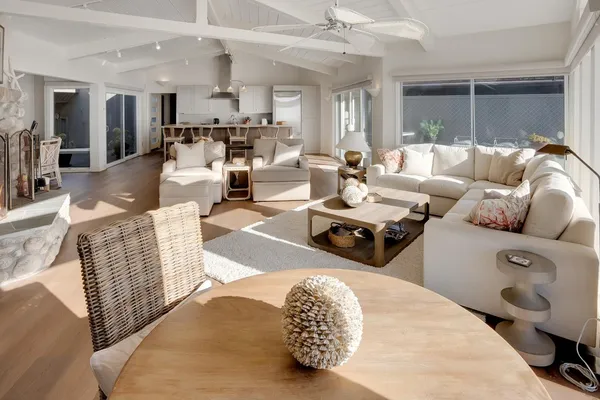a living room with furniture and view of kitchen