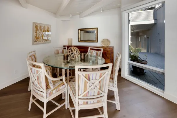 a dining room with furniture and wooden floor