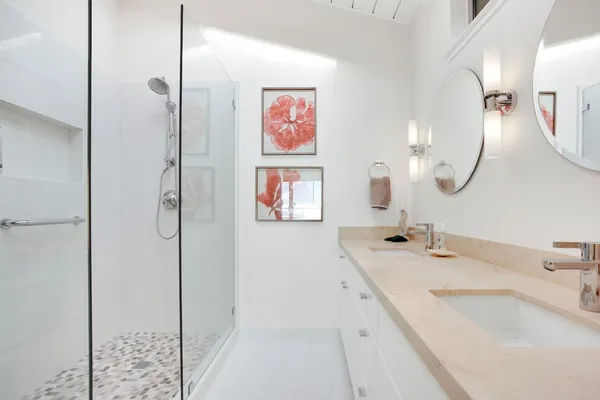 a bathroom with a tub sink and mirror