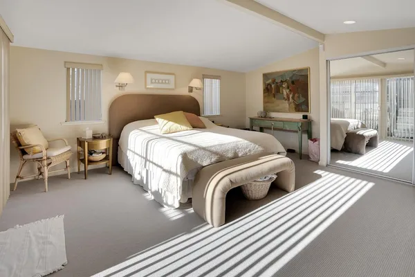 a bed room with a bed and a chair