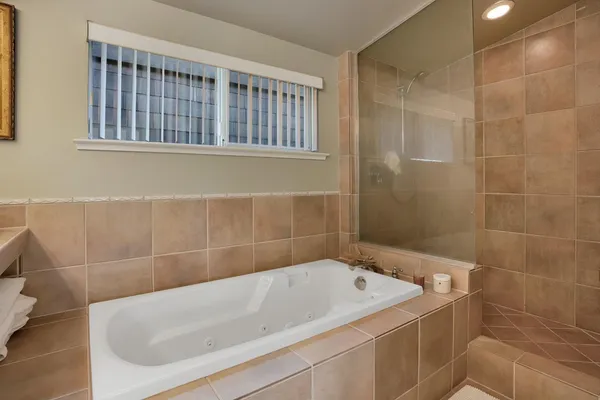 a bathroom with a tub and a shower