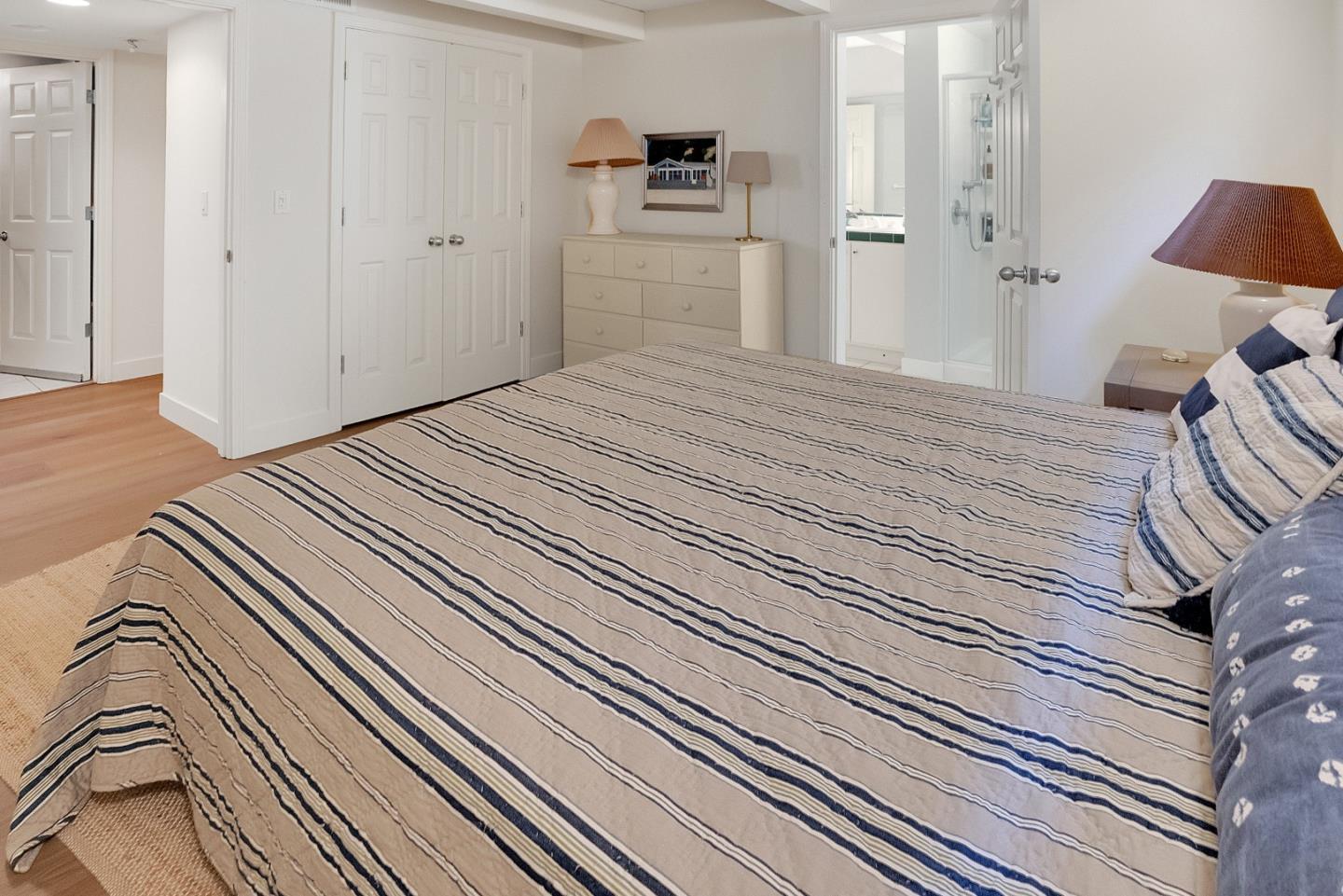 545 Beach Drive Aptos, CA 95003 - Photo 21 of 55 a bedroom with a bed and a lamp on the dresser