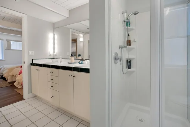 a bathroom with a tub sink and mirror