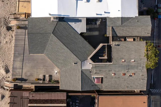 a aerial view of a house with a street