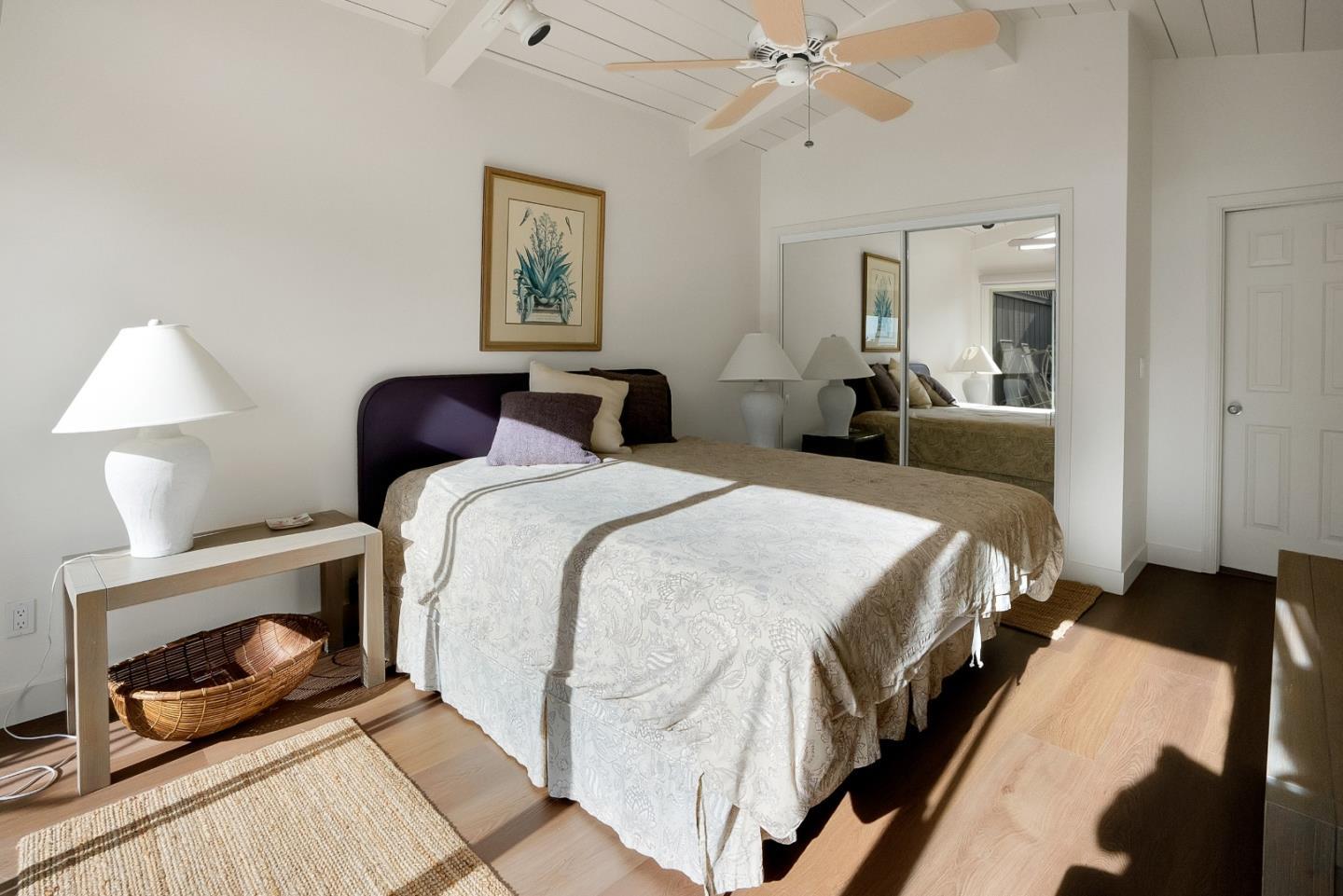 545 Beach Drive Aptos, CA 95003 - Photo 48 of 55 a bedroom with a bed and a chandelier