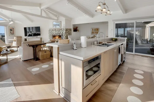 a kitchen with stainless steel appliances a sink stove and cabinets