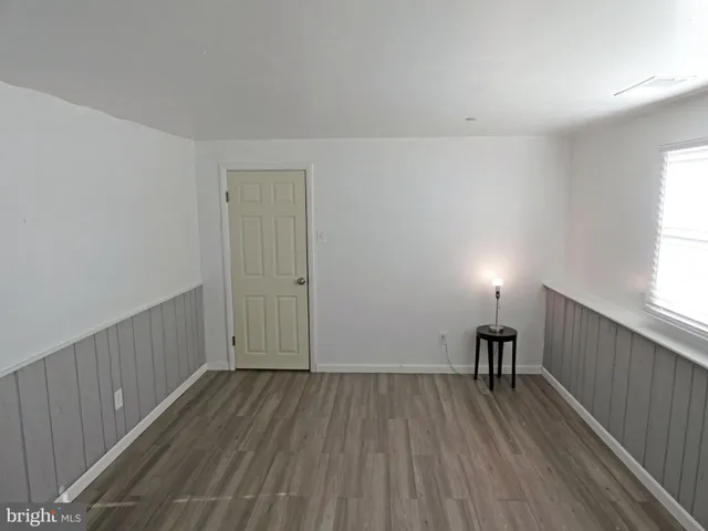 a view of room with wooden floor