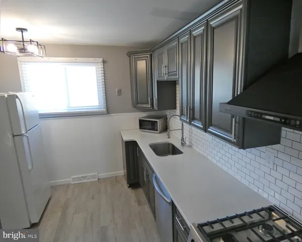 a kitchen with wooden cabinets and sink