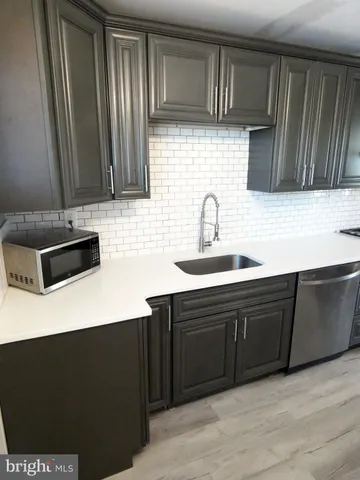 a kitchen with stainless steel appliances wooden cabinets and a sink stove