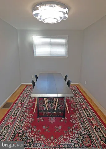 a view of a dining room with furniture and a wooden floor