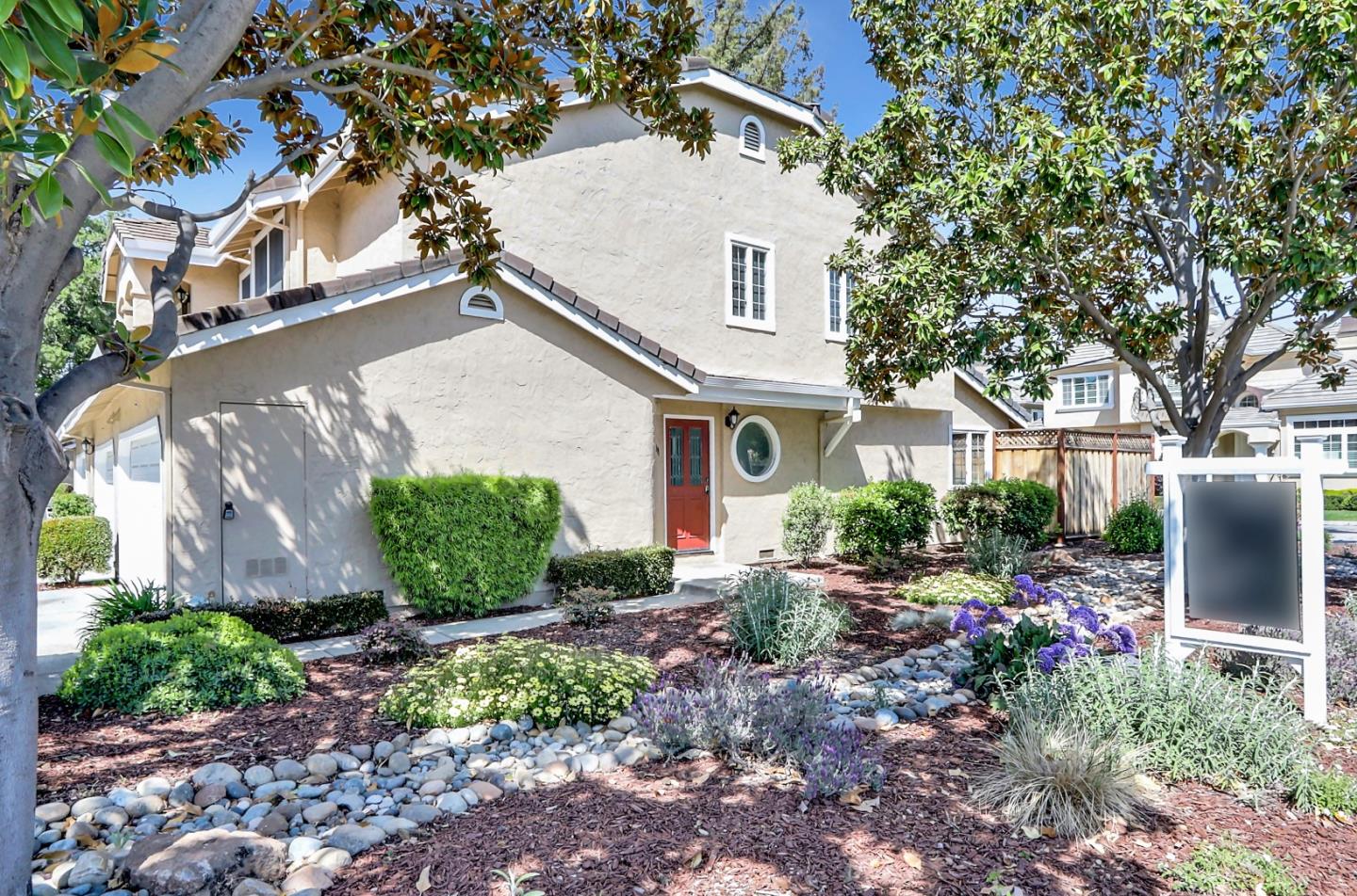 a front view of a house with garden