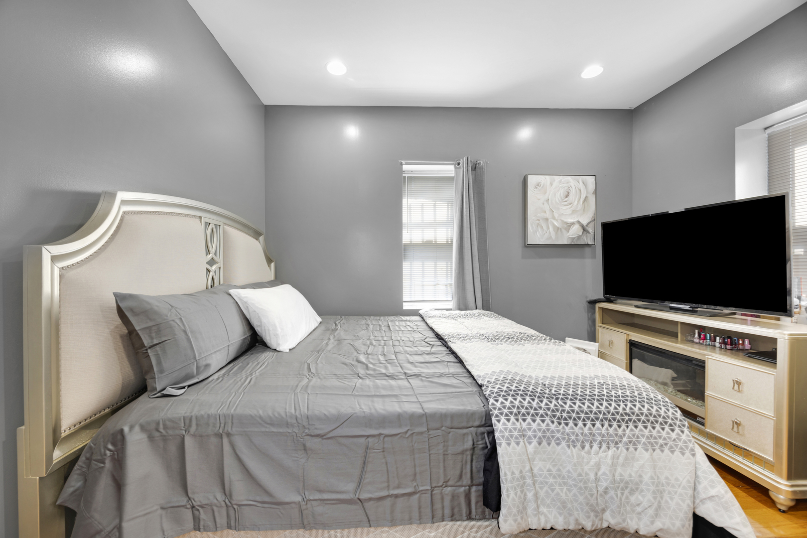 7220 South Carpenter Street Chicago, IL 60621 - Photo 11 of 17 a bedroom with a bed and a flat screen tv