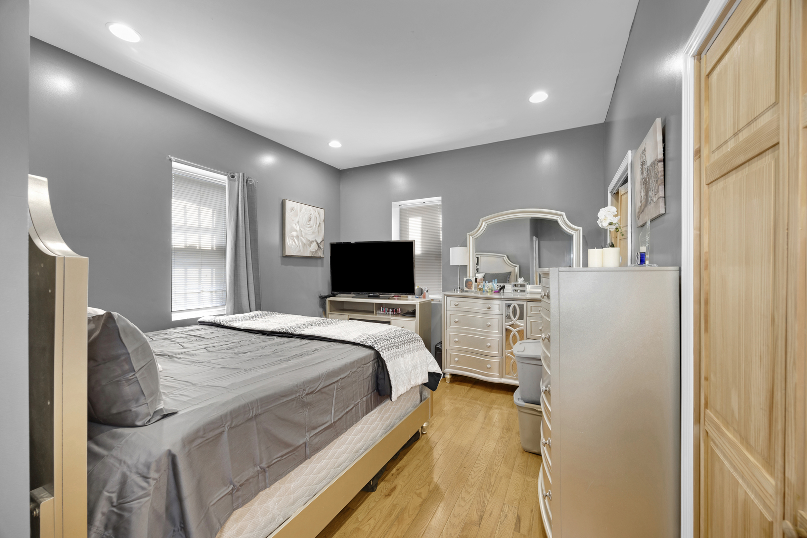 7220 South Carpenter Street Chicago, IL 60621 - Photo 12 of 17 a bedroom with a bed and a flat screen tv