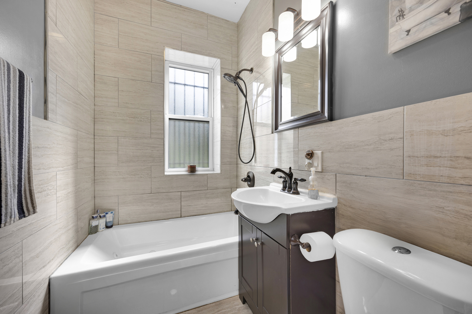 7220 South Carpenter Street Chicago, IL 60621 - Photo 13 of 17 a bathroom with a sink a toilet and a bathtub