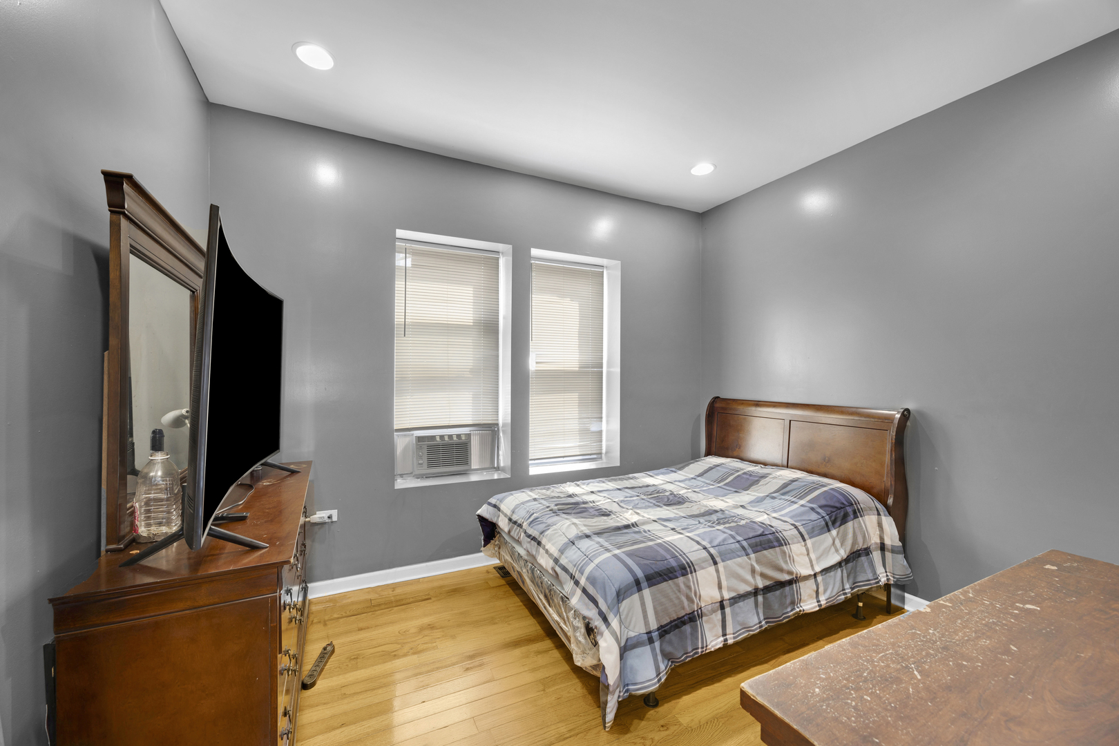 7220 South Carpenter Street Chicago, IL 60621 - Photo 14 of 17 a bedroom with a bed and wooden floor