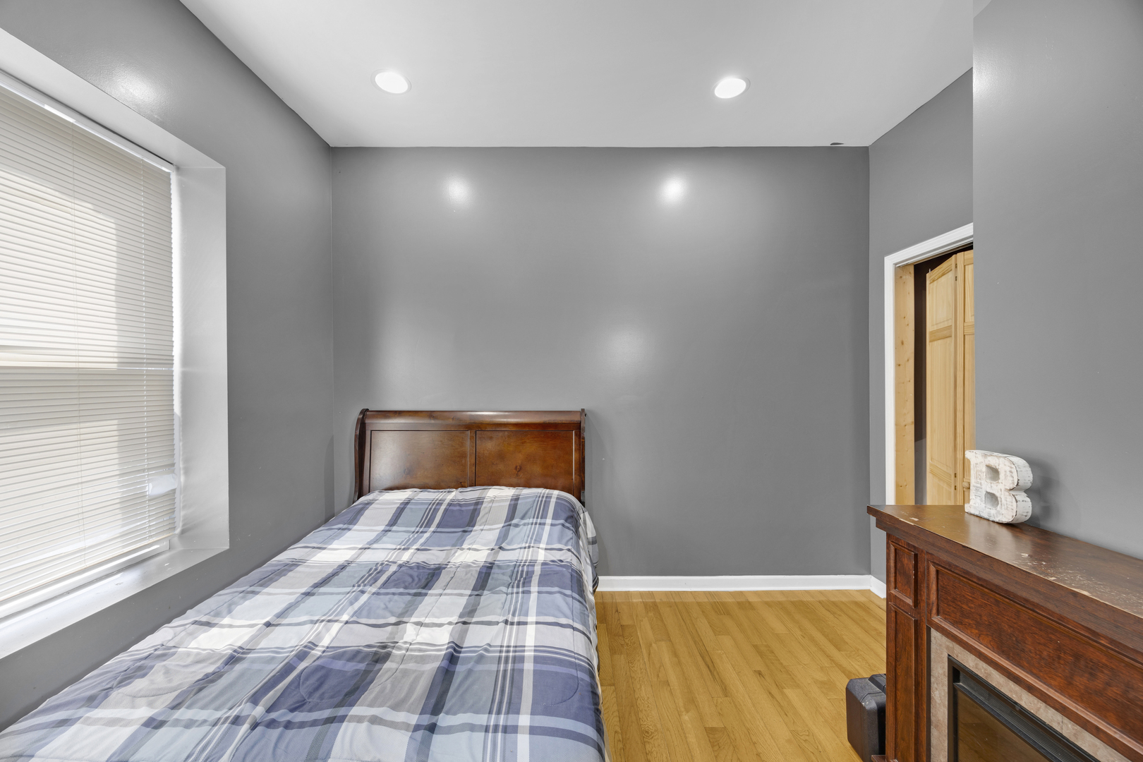 7220 South Carpenter Street Chicago, IL 60621 - Photo 15 of 17 a bedroom with a bed and a window