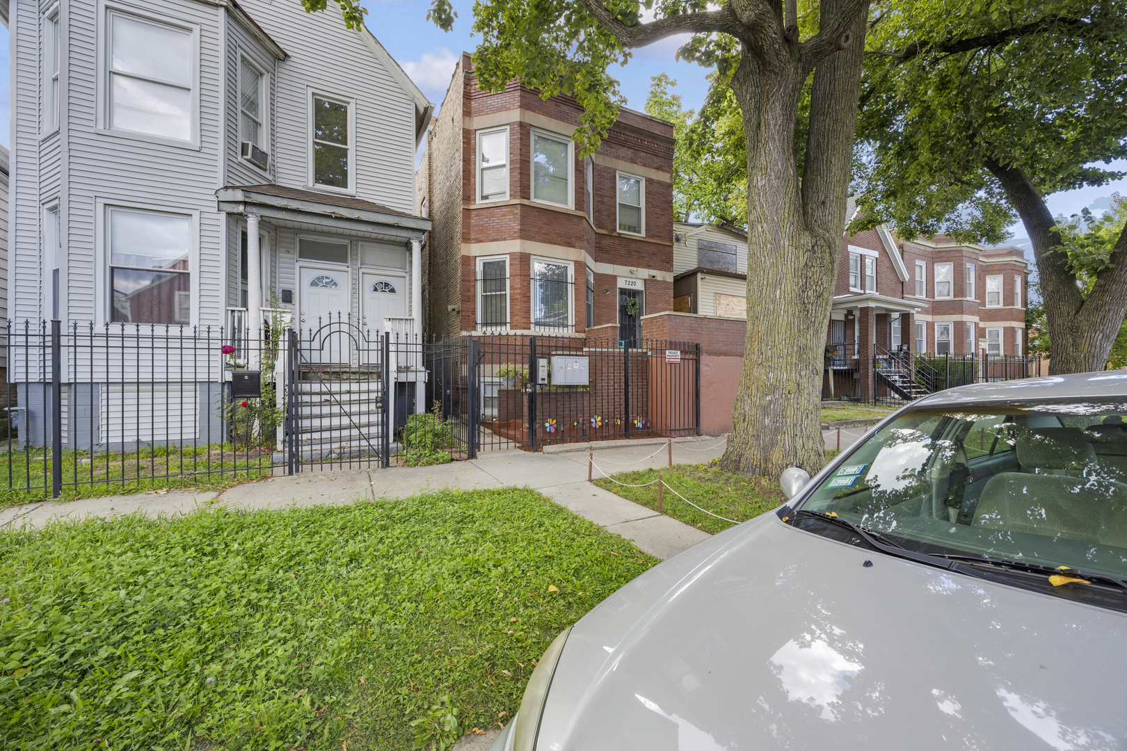 7220 South Carpenter Street Chicago, IL 60621 - Photo 2 of 17 a view of a brick house with a yard and plants