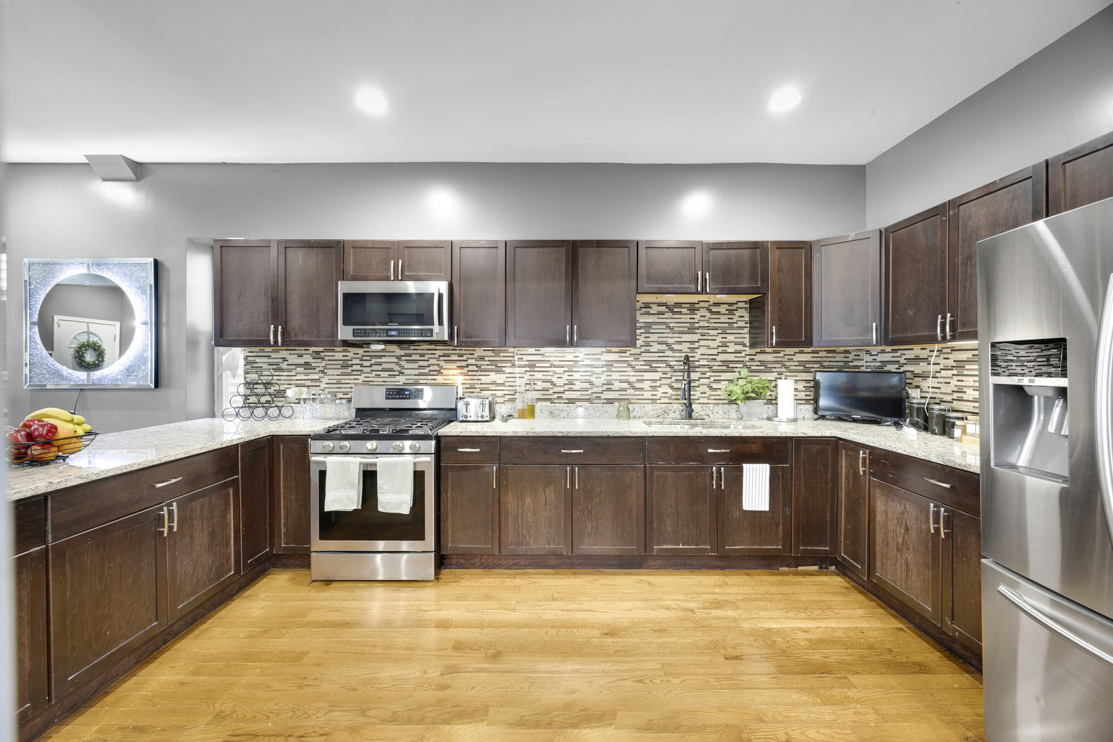 7220 South Carpenter Street Chicago, IL 60621 - Photo 4 of 17 a large kitchen with stainless steel appliances granite countertop a stove sink and cabinets