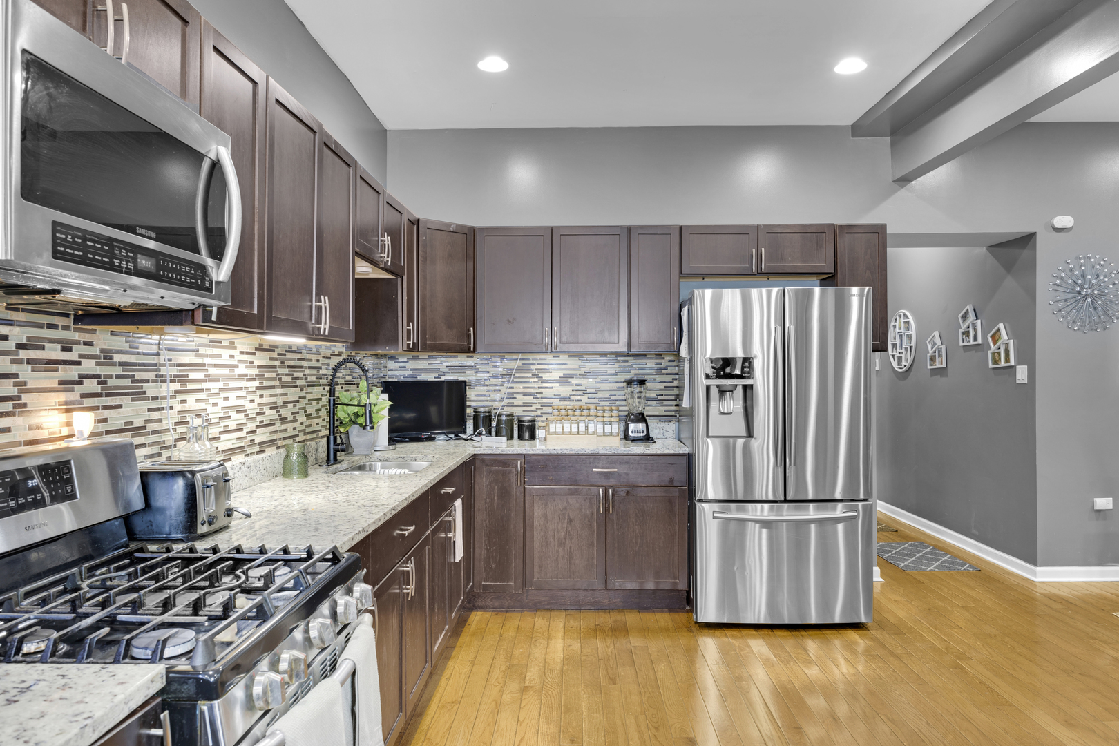 7220 South Carpenter Street Chicago, IL 60621 - Photo 5 of 17 a kitchen with stainless steel appliances granite countertop a refrigerator stove microwave and sink