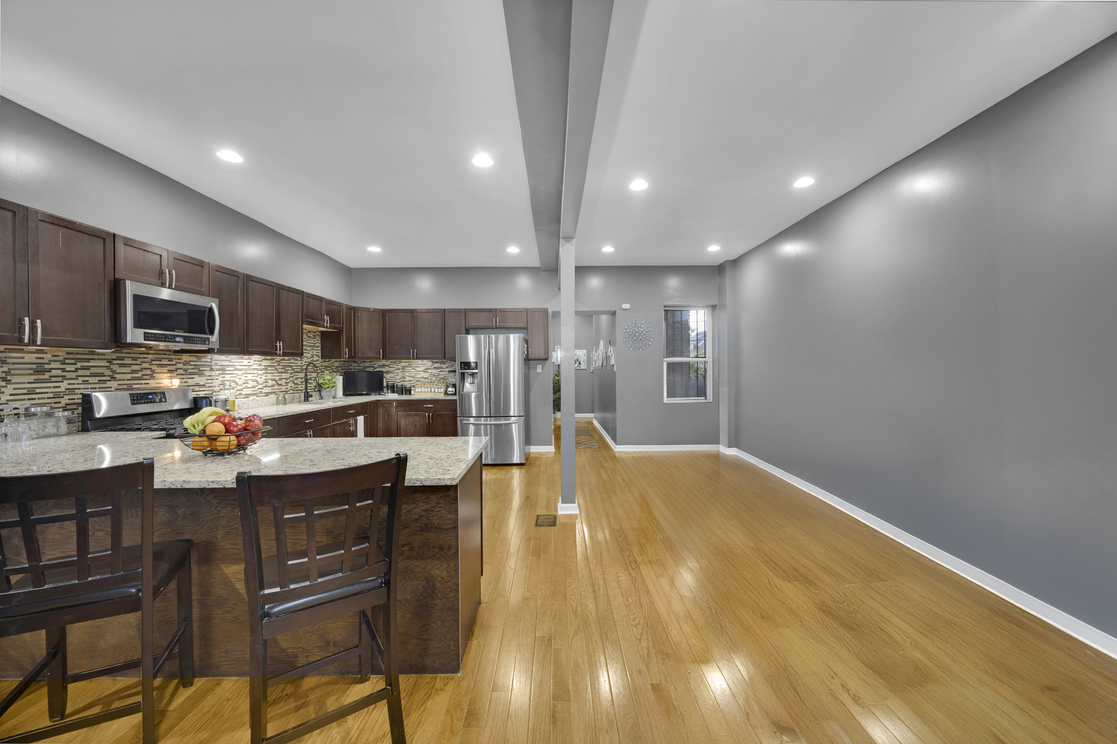 7220 South Carpenter Street Chicago, IL 60621 - Photo 7 of 17 a kitchen with stainless steel appliances a refrigerator a stove a sink dishwasher with a dining table and chairs
