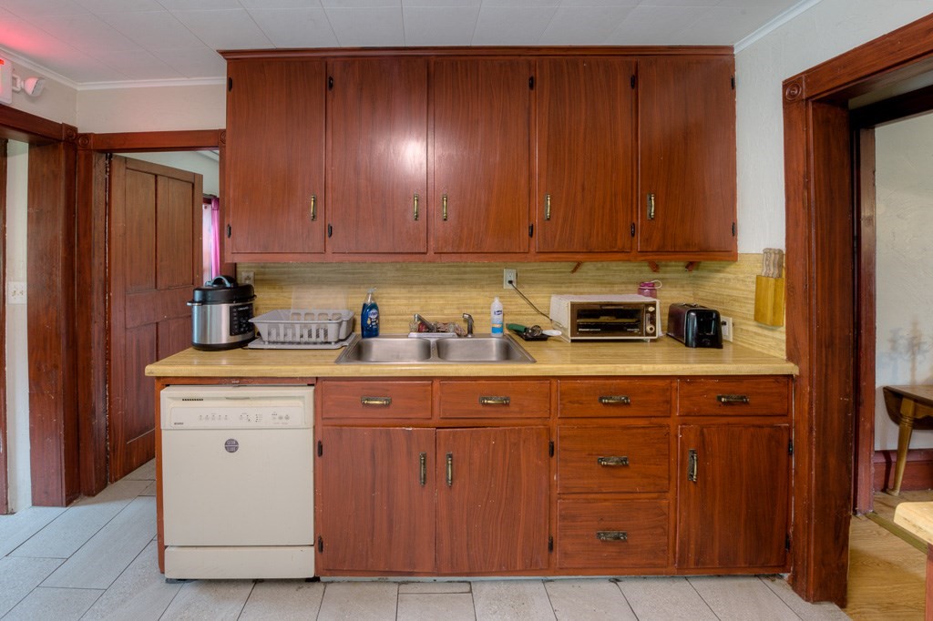 92 Mill Street Lancaster, MA 01523 - Photo 13 of 42 a kitchen with stainless steel appliances granite countertop wooden cabinets a sink and dishwasher