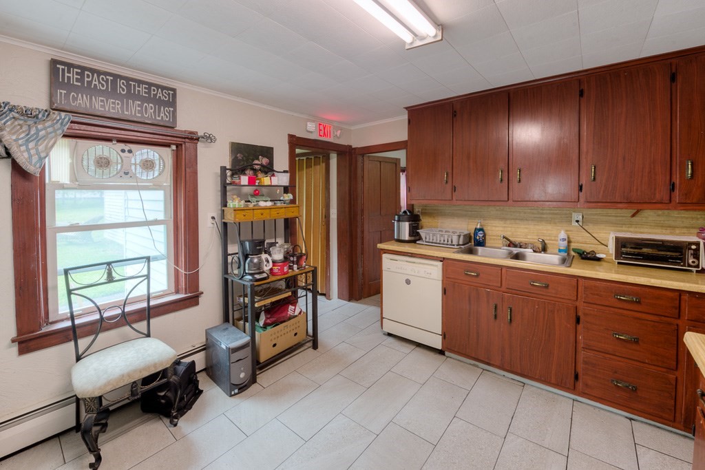 92 Mill Street Lancaster, MA 01523 - Photo 14 of 42 a view of a kitchen with fridge and workspace