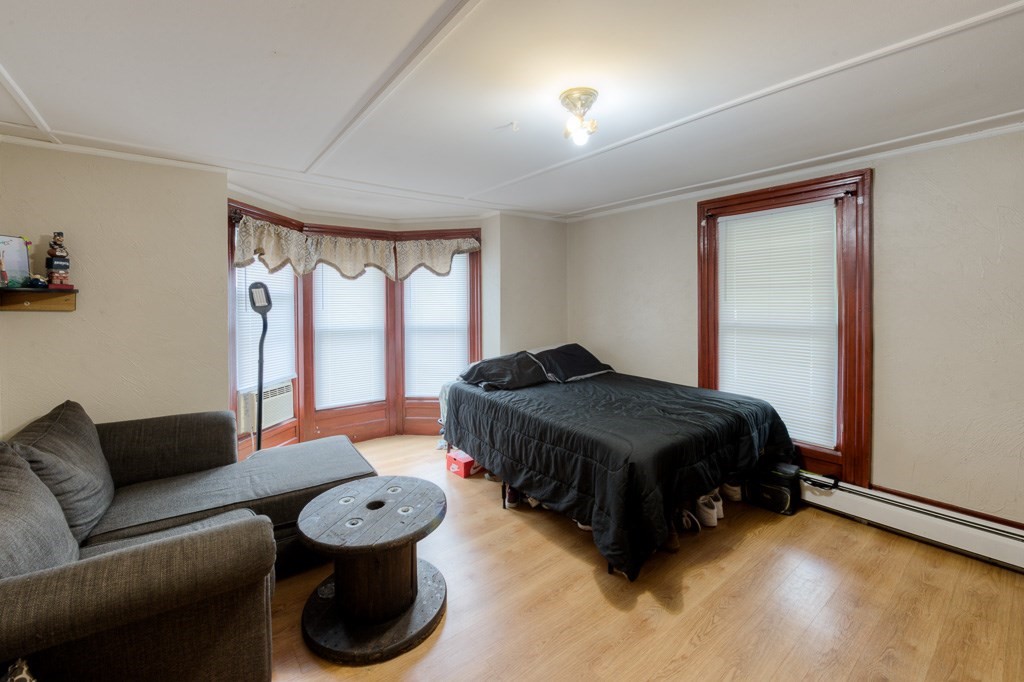 92 Mill Street Lancaster, MA 01523 - Photo 17 of 42 a spacious bedroom with a bed and a large window