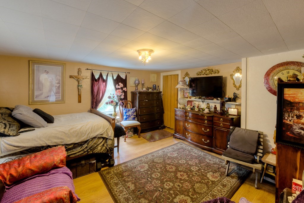 92 Mill Street Lancaster, MA 01523 - Photo 19 of 42 a living room with furniture and a flat screen tv