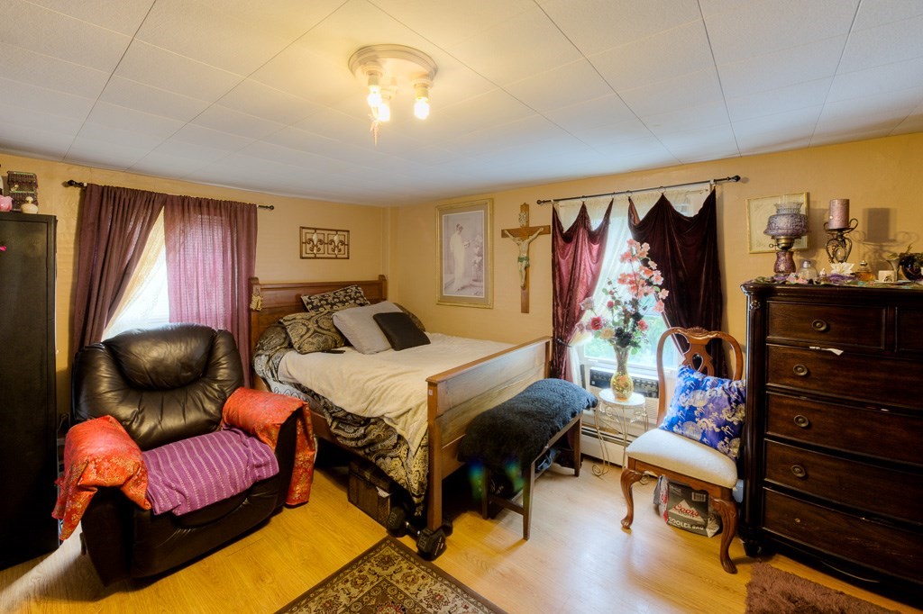 92 Mill Street Lancaster, MA 01523 - Photo 20 of 42 a bedroom with furniture and a chandelier