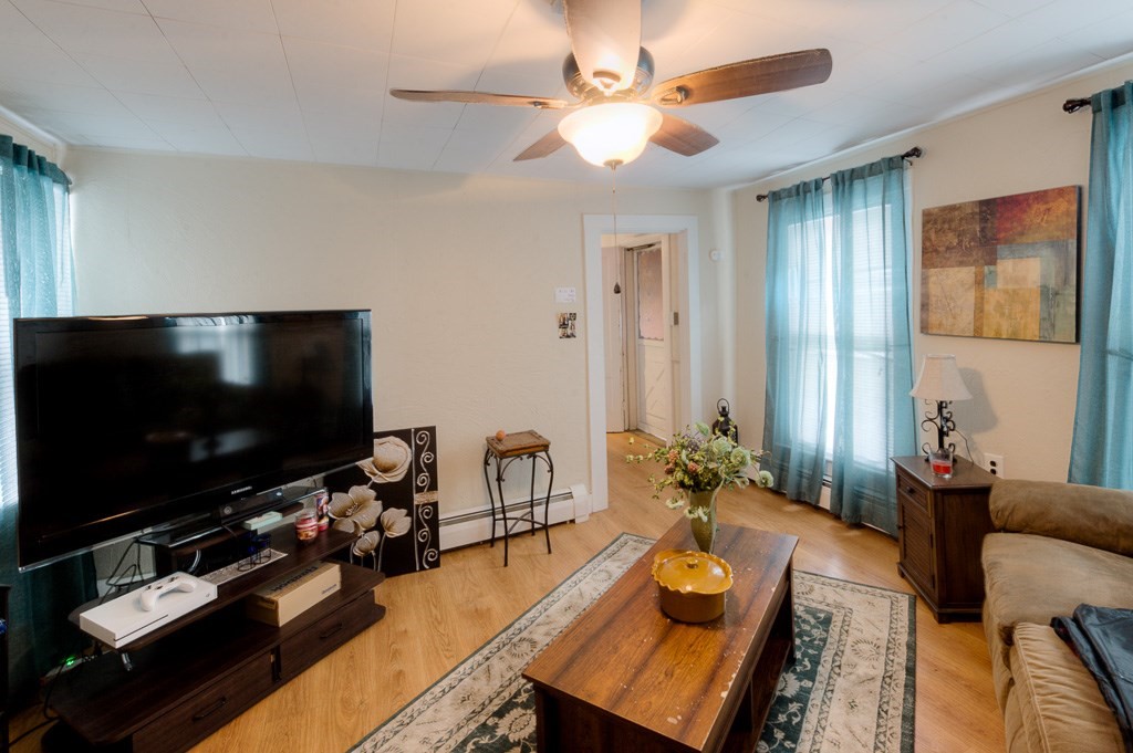 92 Mill Street Lancaster, MA 01523 - Photo 22 of 42 a living room with furniture and a flat screen tv