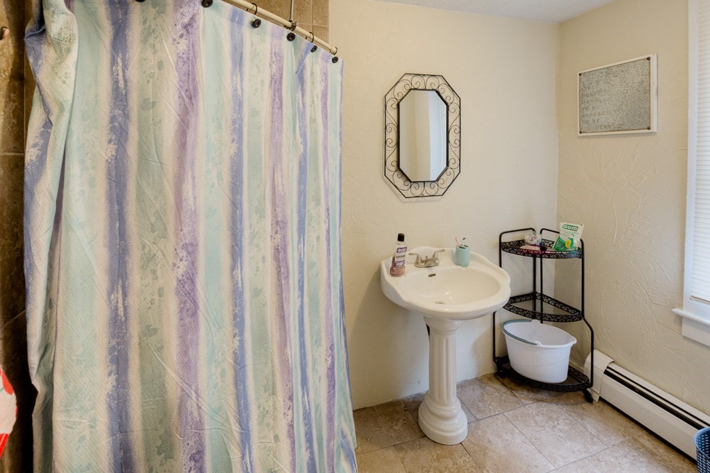 92 Mill Street Lancaster, MA 01523 - Photo 23 of 42 a bathroom with a sink toilet and a mirror