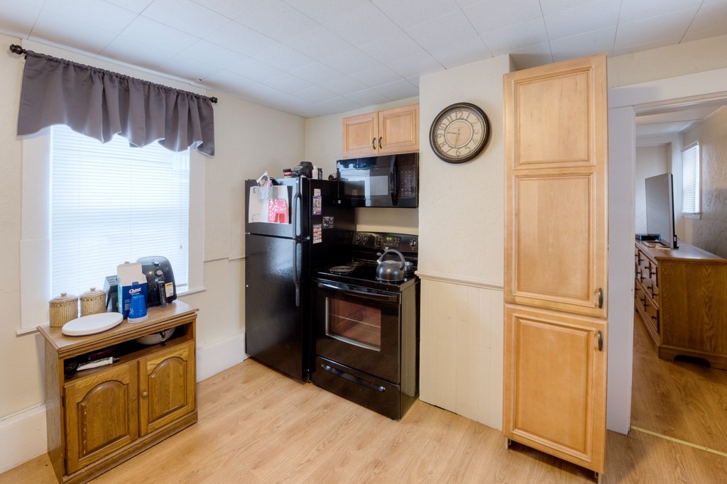 92 Mill Street Lancaster, MA 01523 - Photo 24 of 42 a kitchen with stainless steel appliances granite countertop a refrigerator a stove a sink and a refrigerator