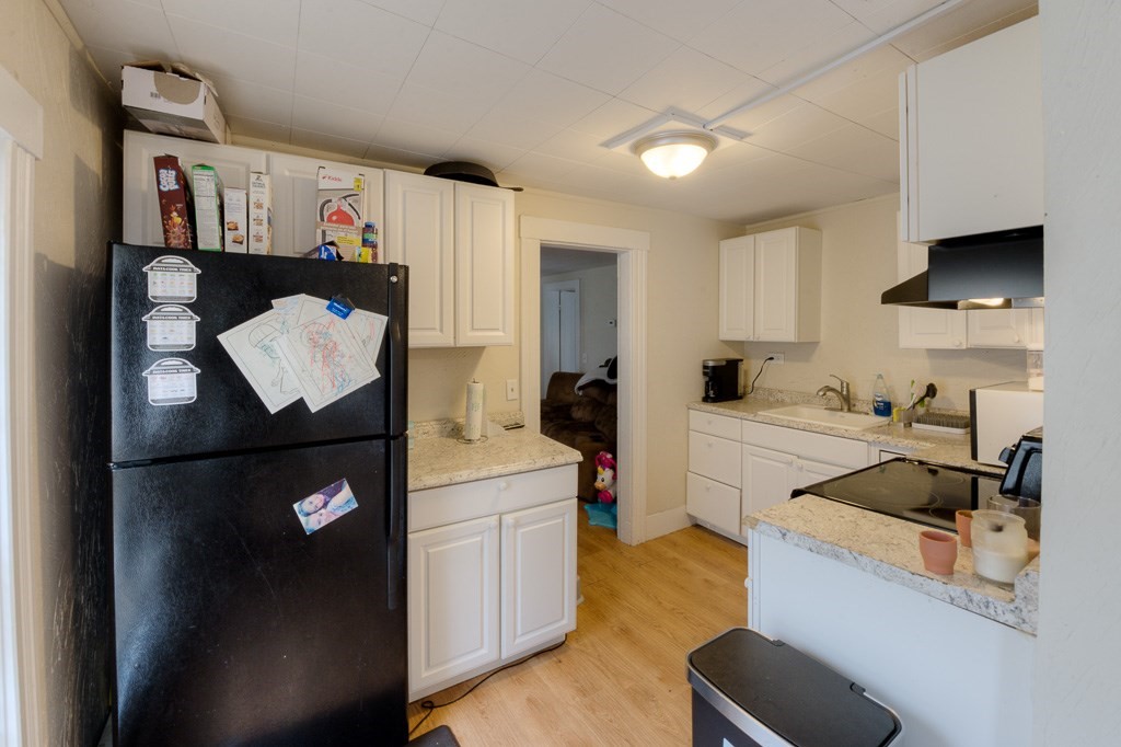 92 Mill Street Lancaster, MA 01523 - Photo 28 of 42 a kitchen with a refrigerator and a sink